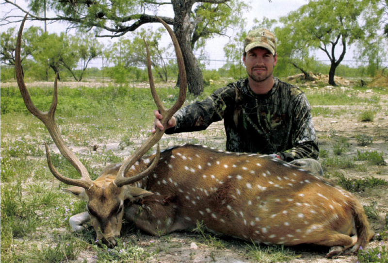 hunter with axis buck