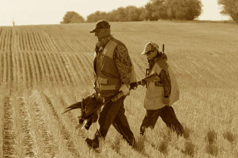 old man and youth bird hunter