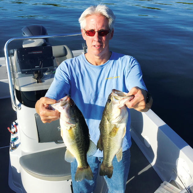 Craig Packard of Humminbird holds a pair of four-pound largemouth bass from Lake Eufaula. 
