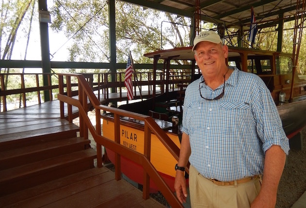 The author stands next to one of the most famous boats in history, Hemingway's Pilar.