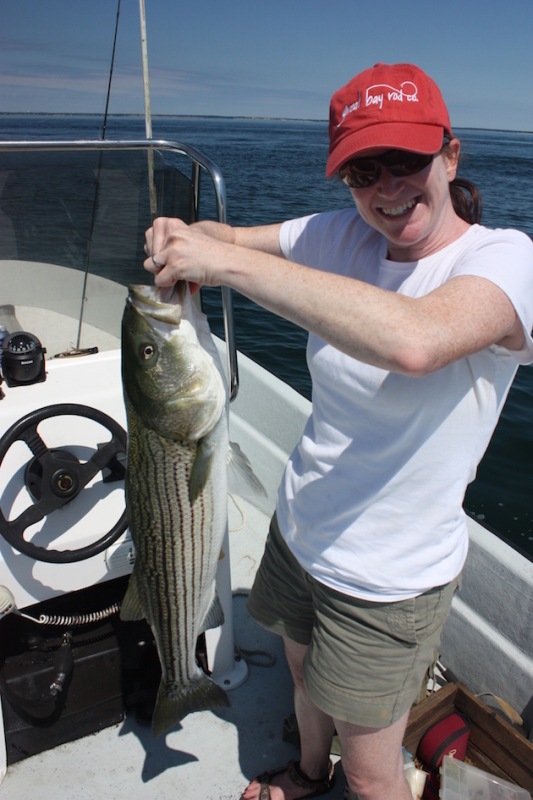 Angela Keer lands a three-foot striper.