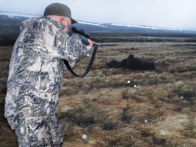 The author prepares for follow-up shots, but after three .375 rounds, this bear was down for the count.