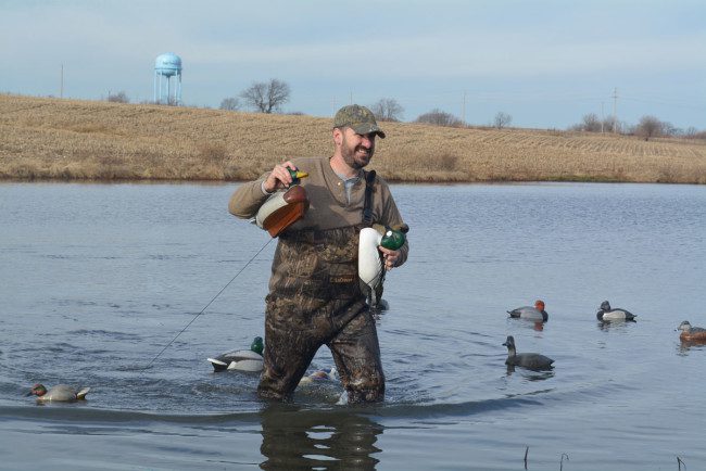 Tom Modin rearranges his hand-carved decoys during a recent duck hunt.