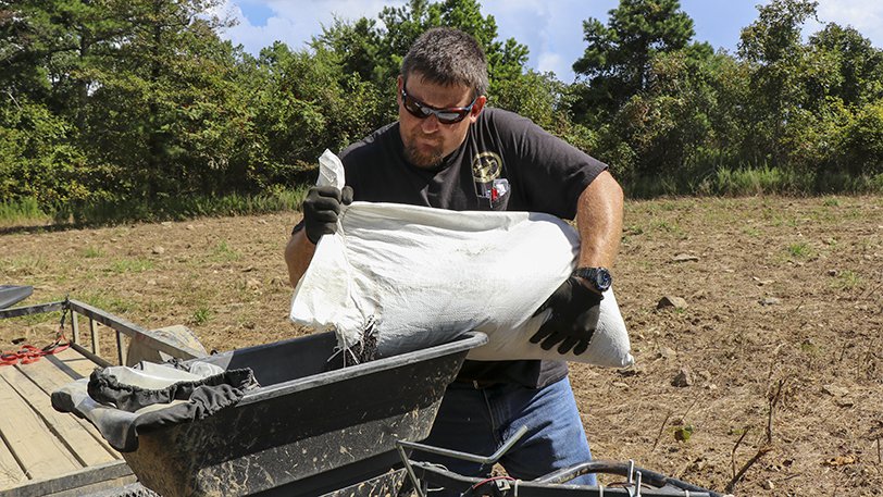 putting clover seed into spreader