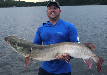 man holding MN state record muskie