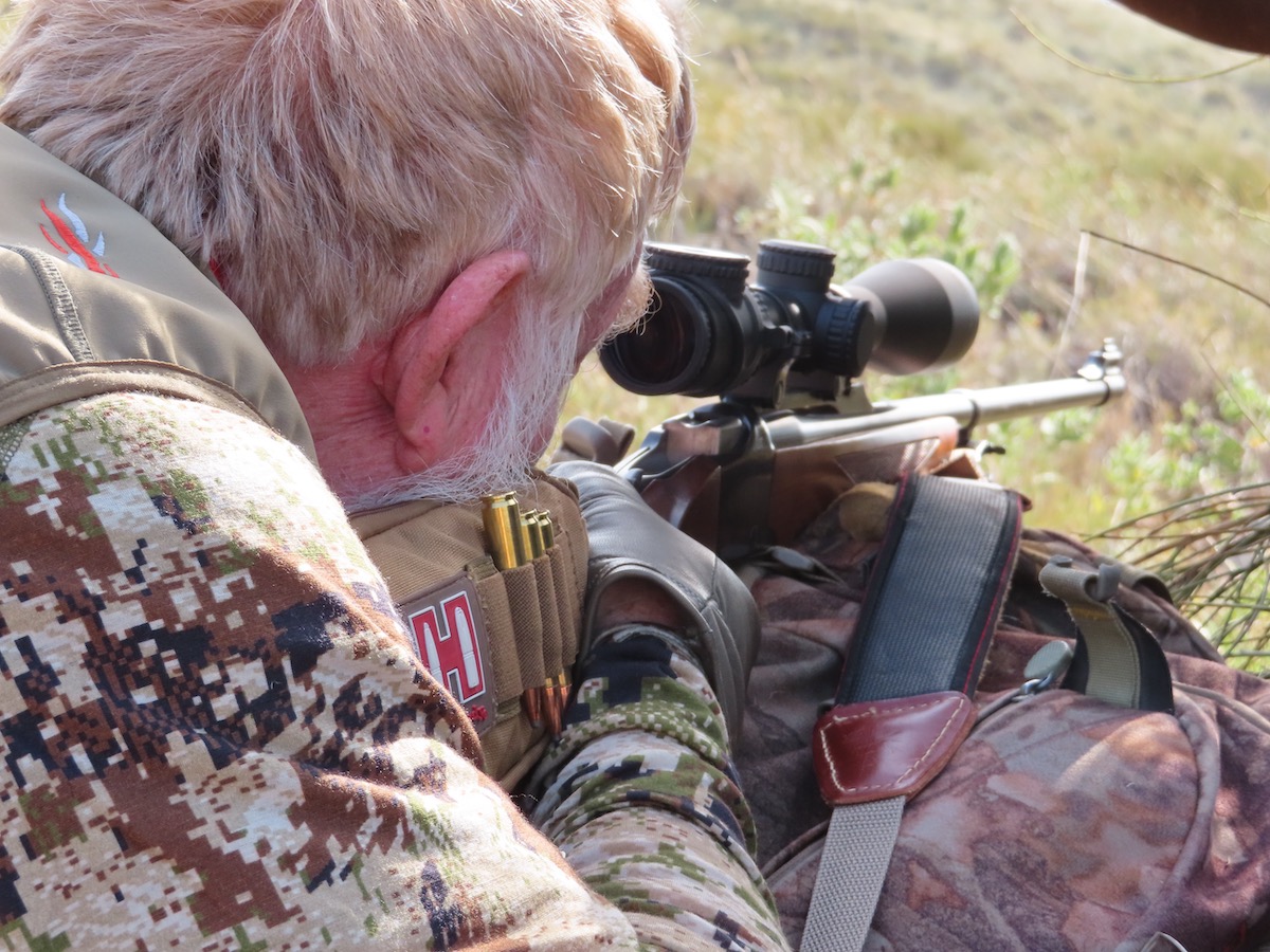 man shooting rifle long range hunting accuracy