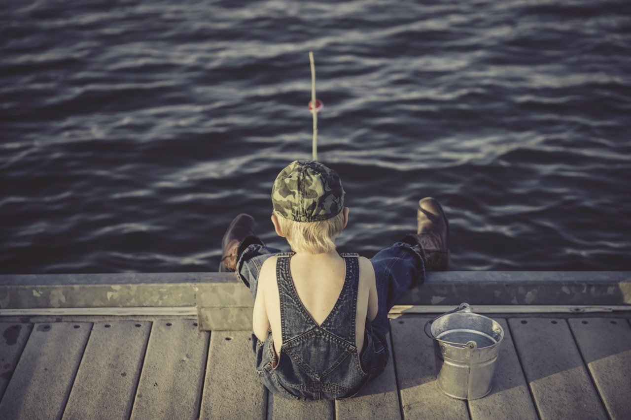 boy fishing on dock