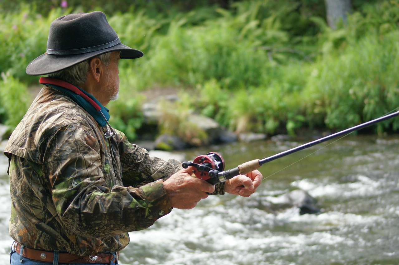 man fly fishing in river