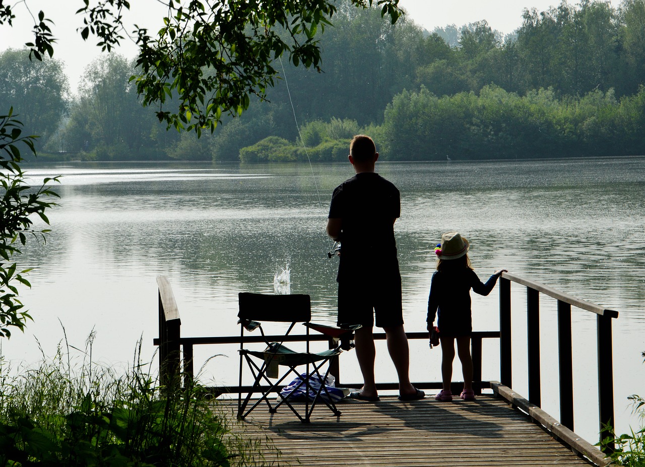 father daughter fishing on dock