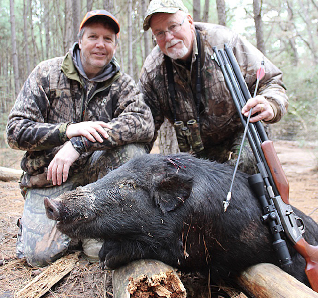 hunters with hog