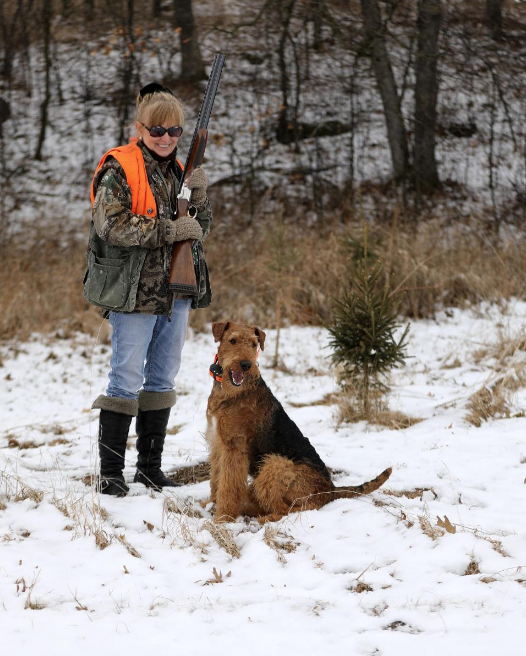 woman hunter with airdale dog