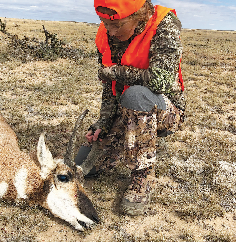 young girl hunter with pronghorn buck