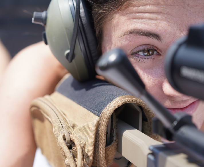 woman rifle scope shooting