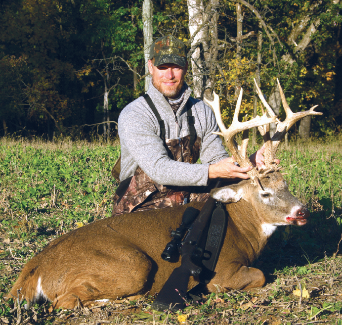 hunter with buck whitetail deer