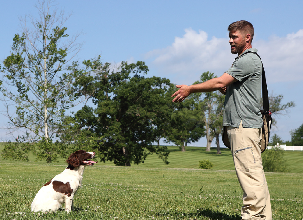 trainer with spaniel dog