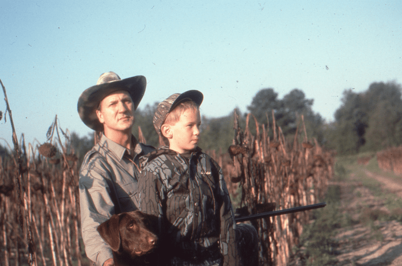 father son dove hunt with chocolate lab dog